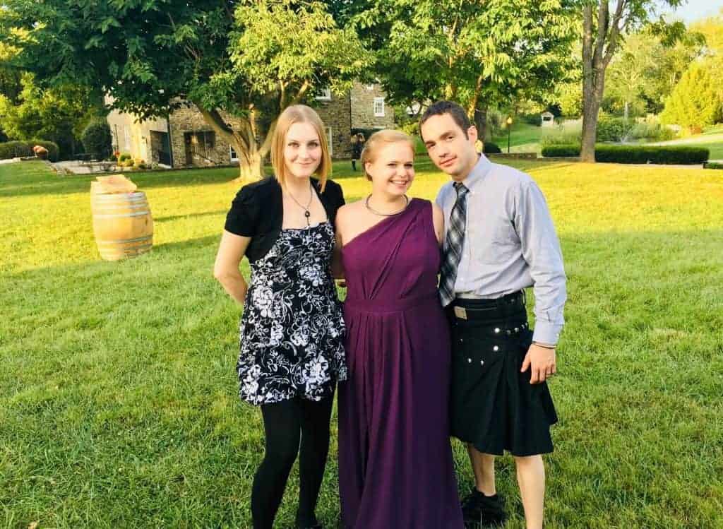 Cassie, Amanda, and Josh dressed up for a friend's wedding